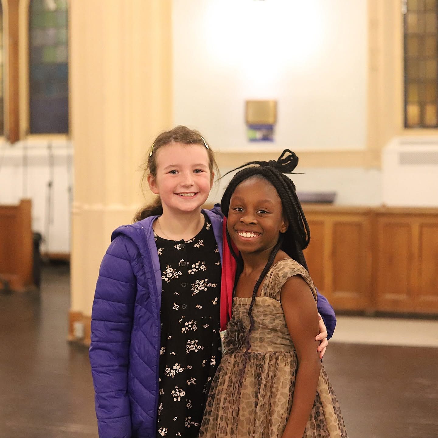 Two young students smiling together at a Piano Place music camp in Ottawa