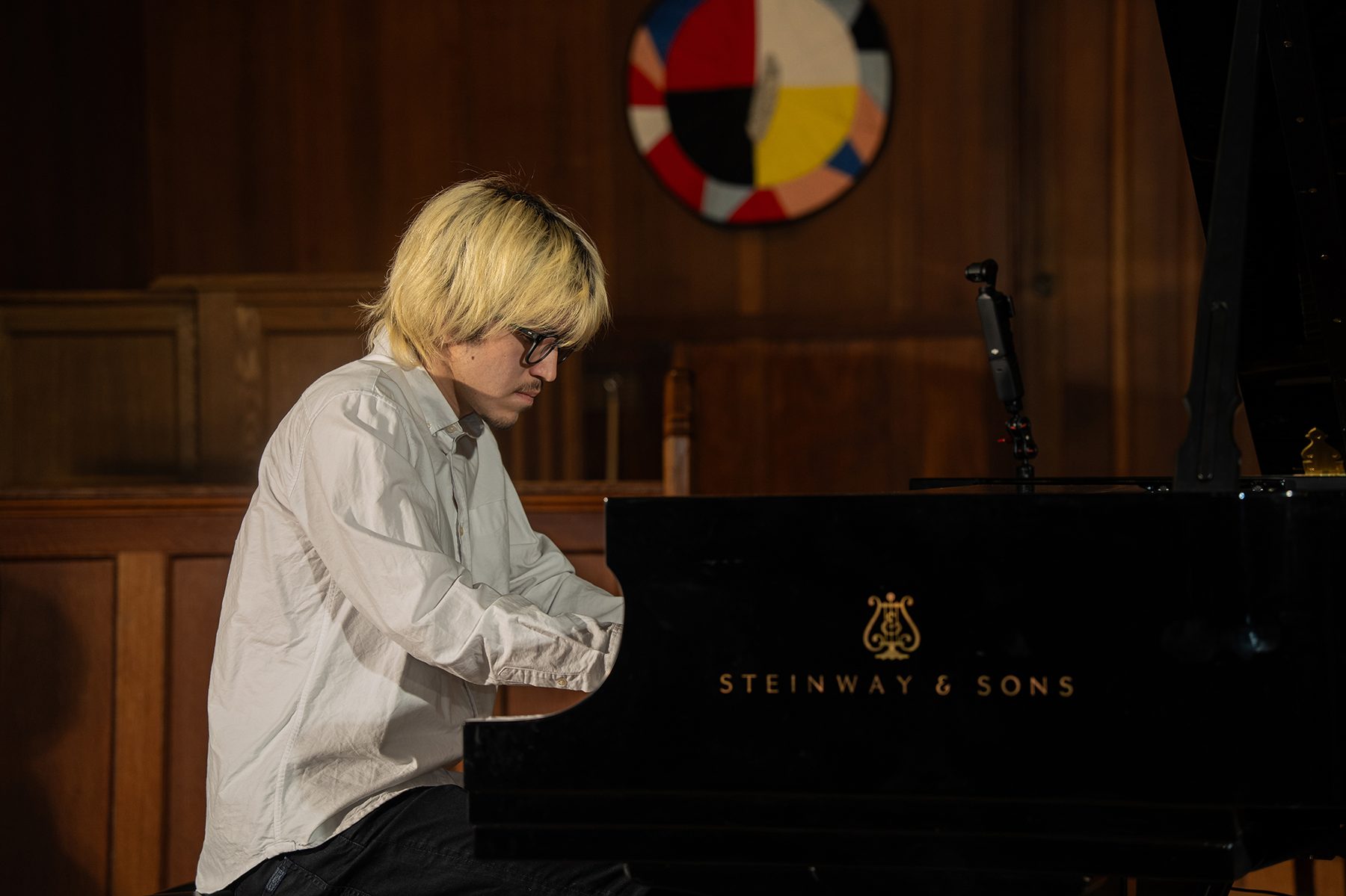 Young performer speaking to the audience at a showcase